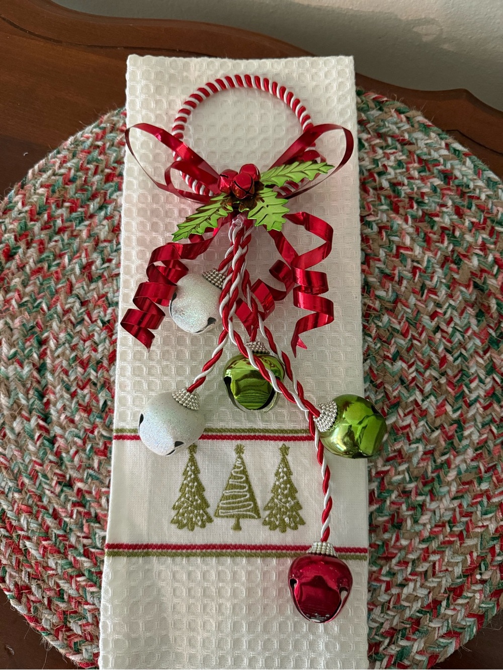 Decorative towel and jingle door hanger.